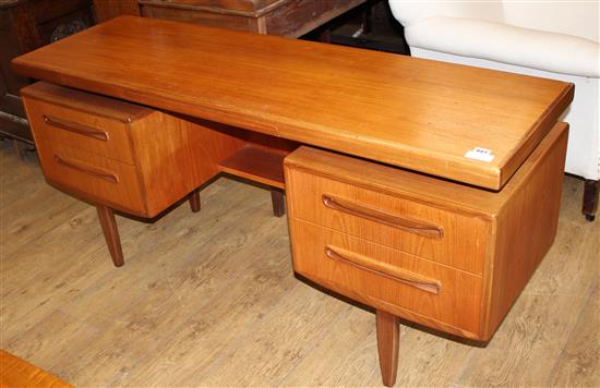 A 1950s G-Plan teak dressing table, fitted five drawers, W.152cm D.46cm H.70cm
